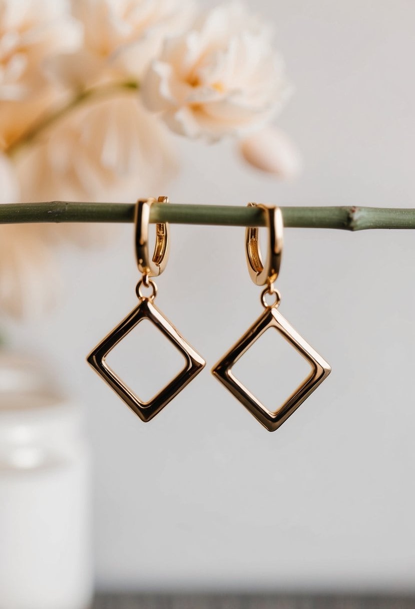 A close-up of geometric gold dangle earrings against a soft, romantic background