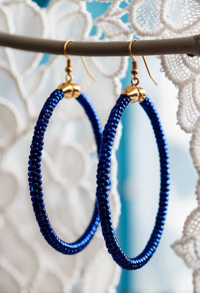 A pair of royal blue beaded hoops dangle elegantly against a soft, white lace background, evoking a sense of sophistication and romance