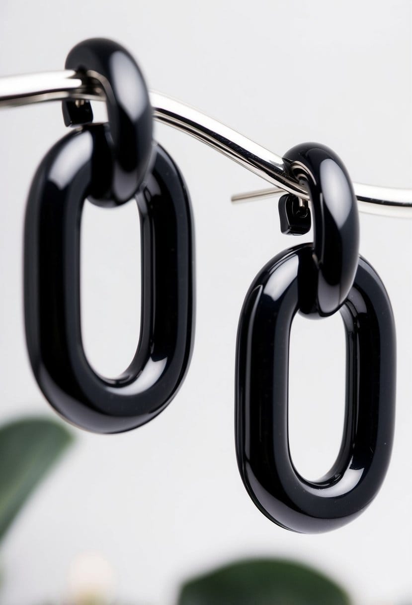 A close-up of elegant black open link earrings by Givenchy, set against a white background