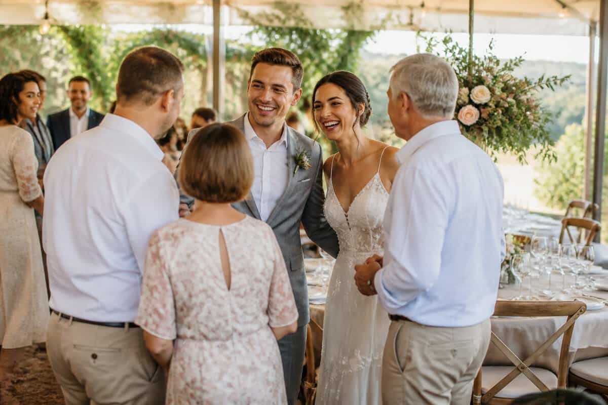 A newlywed couple welcomes guests at an elegant, affordable wedding reception in a Durbanville garden venue.