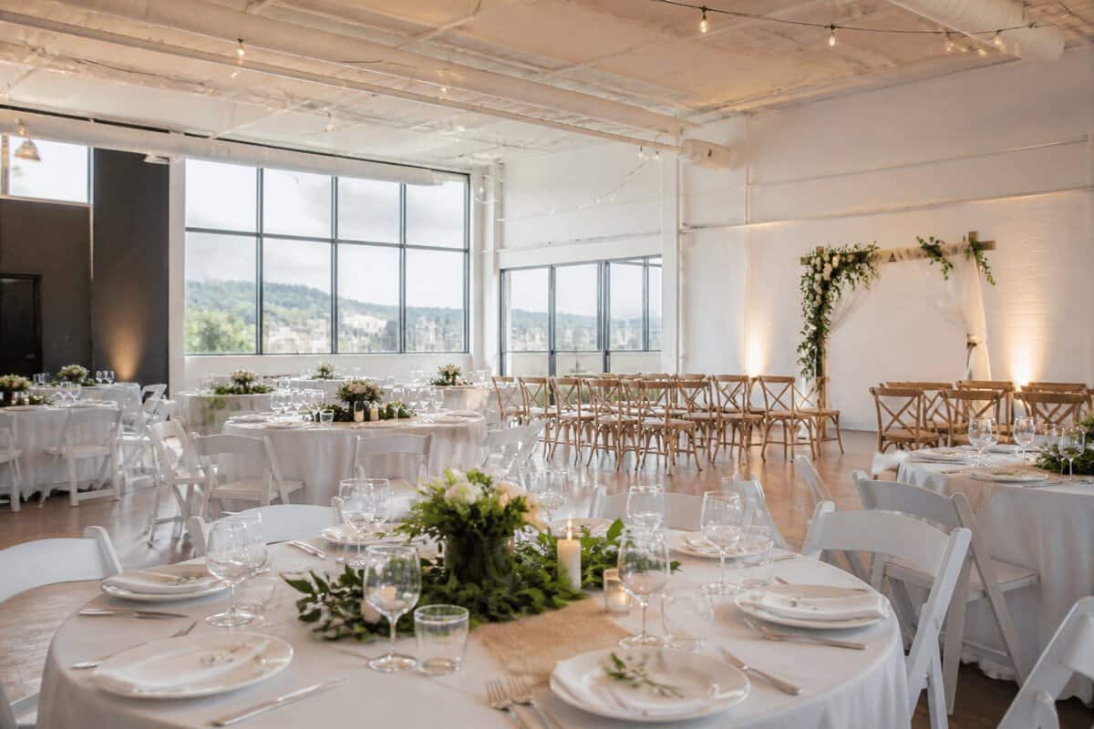 A simple wedding reception arranged in a bright community venue.