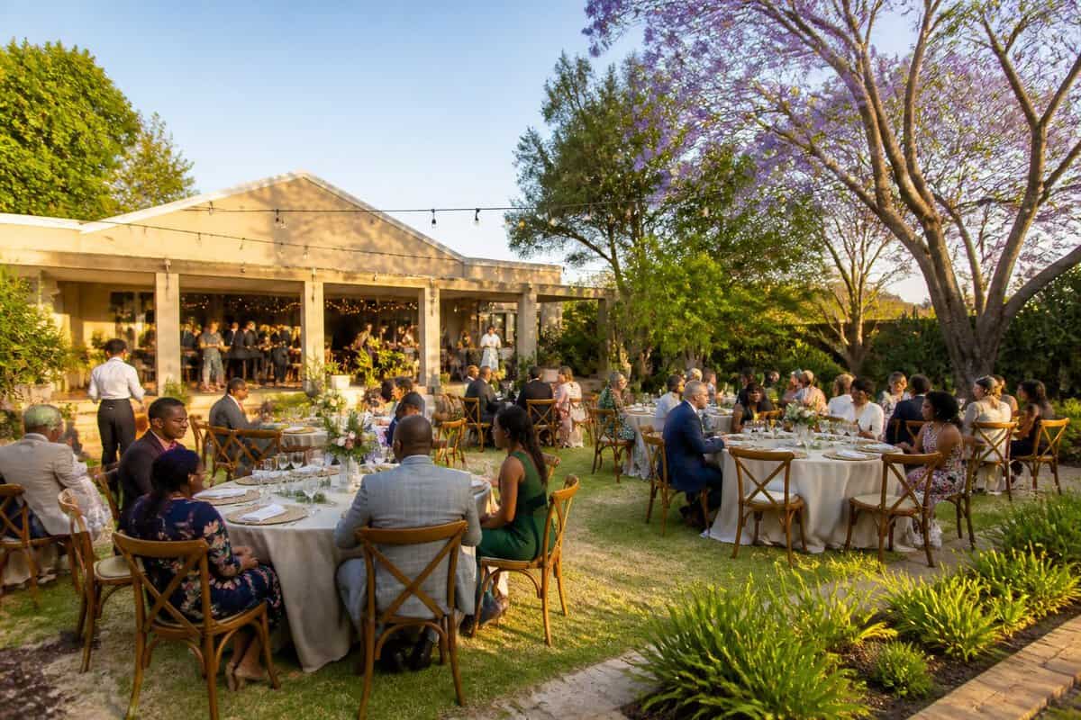 Guests gather at an affordable garden wedding venue in Pretoria with simple reception tables and accessible walkways.