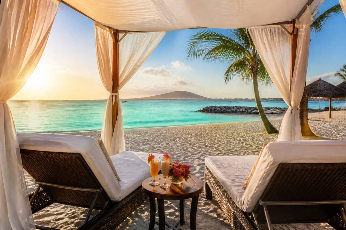 A romantic beachfront resort cabana for two overlooking the turquoise sea in Aruba.