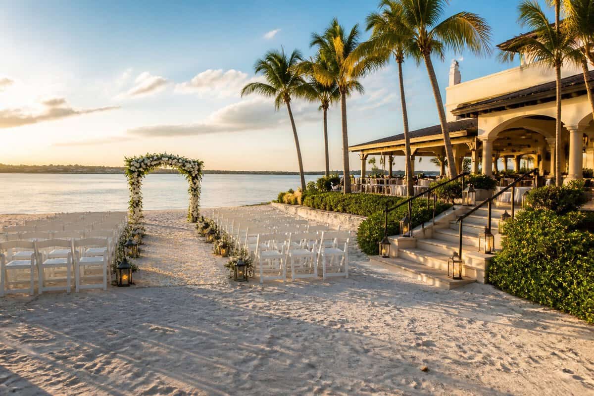 Beachfront resort wedding setup beside calm Gulf Coast waters in Fort Myers.