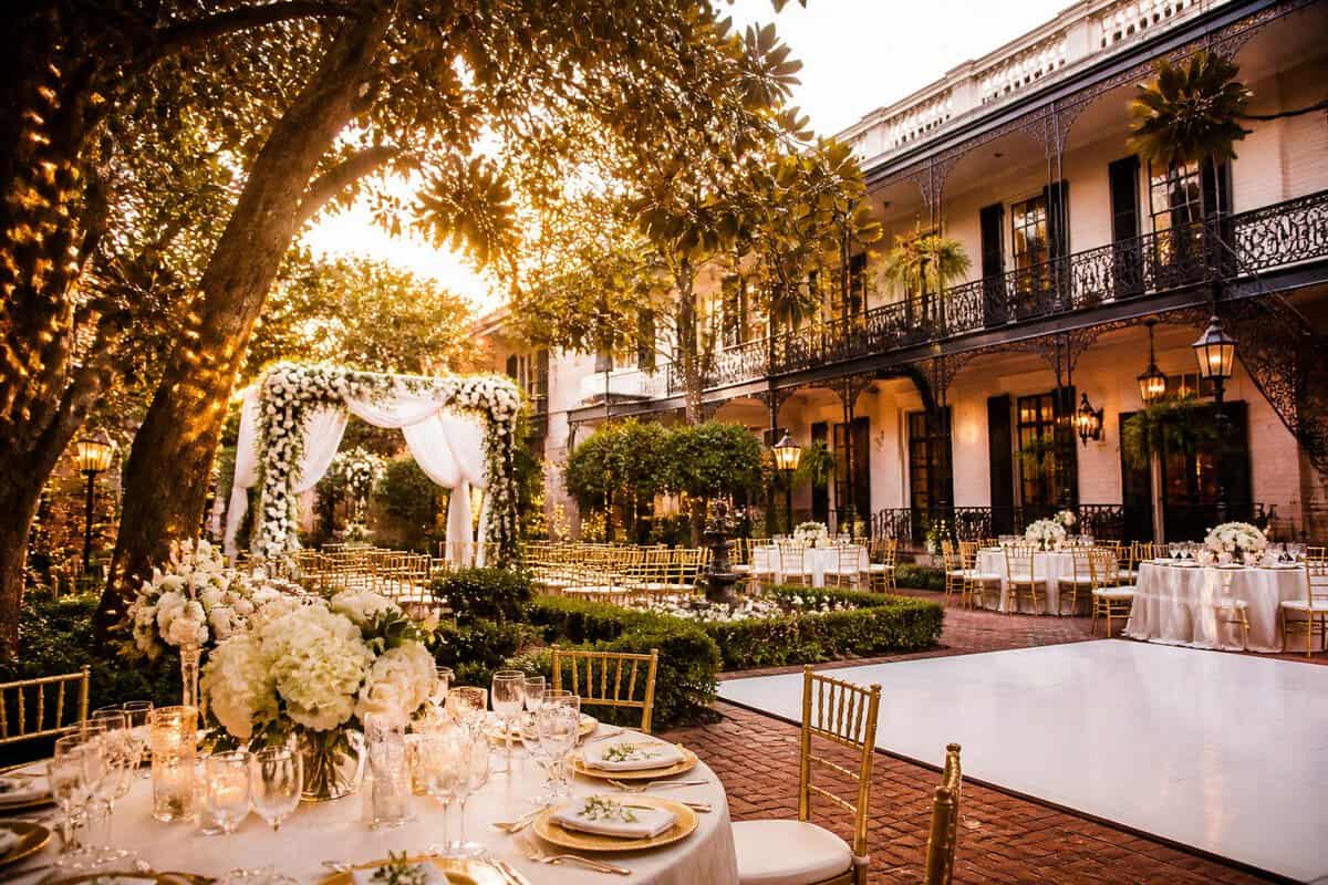 An elegant New Orleans wedding venue courtyard decorated for a ceremony and reception.