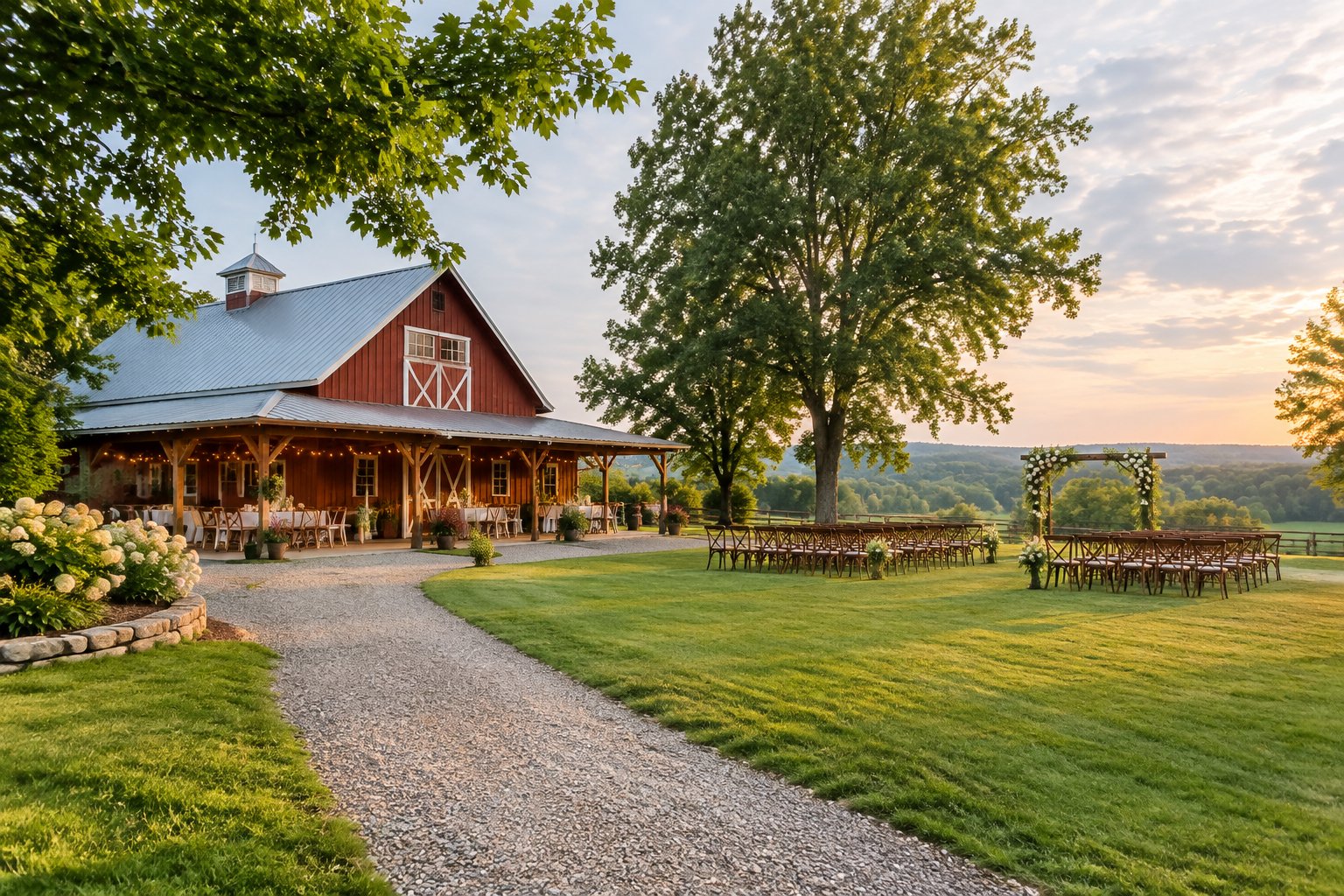 A rustic red barn wedding venue with an outdoor ceremony area, green lawn, trees, and floral decorations.