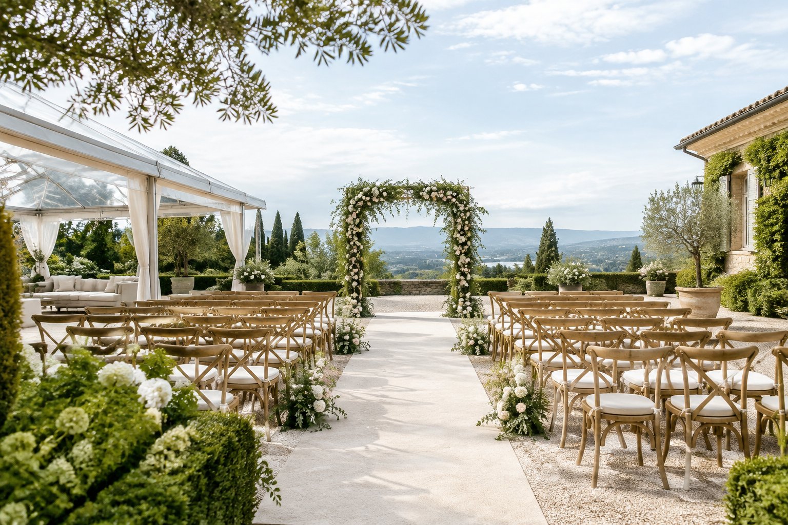 An elegant outdoor wedding ceremony venue with a floral arch, guest chairs, and a clear aisle.
