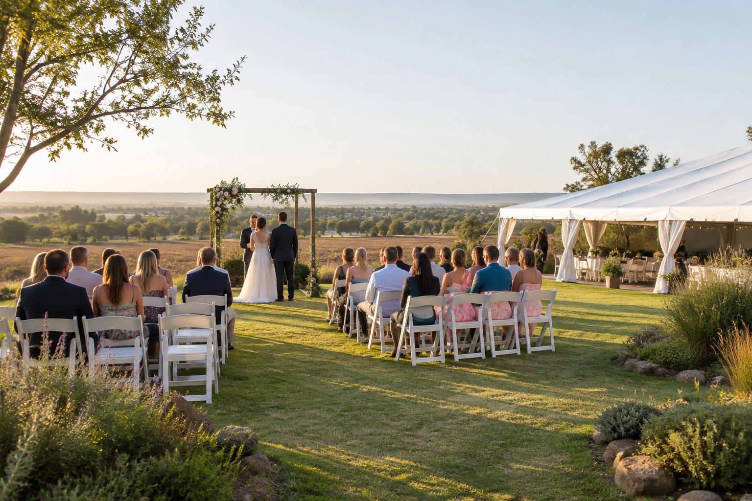 An affordable outdoor wedding venue with simple seating, a floral arch, and a reception marquee on a landscaped lawn.