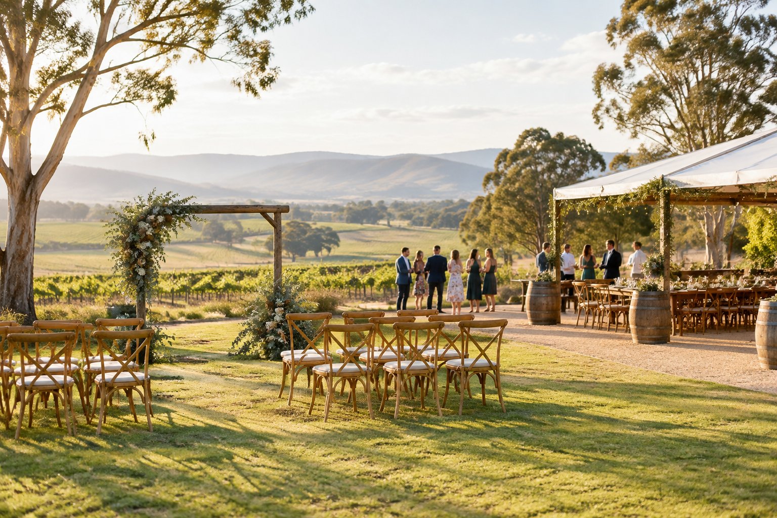 An intimate outdoor wedding setup at a rustic vineyard venue surrounded by countryside.