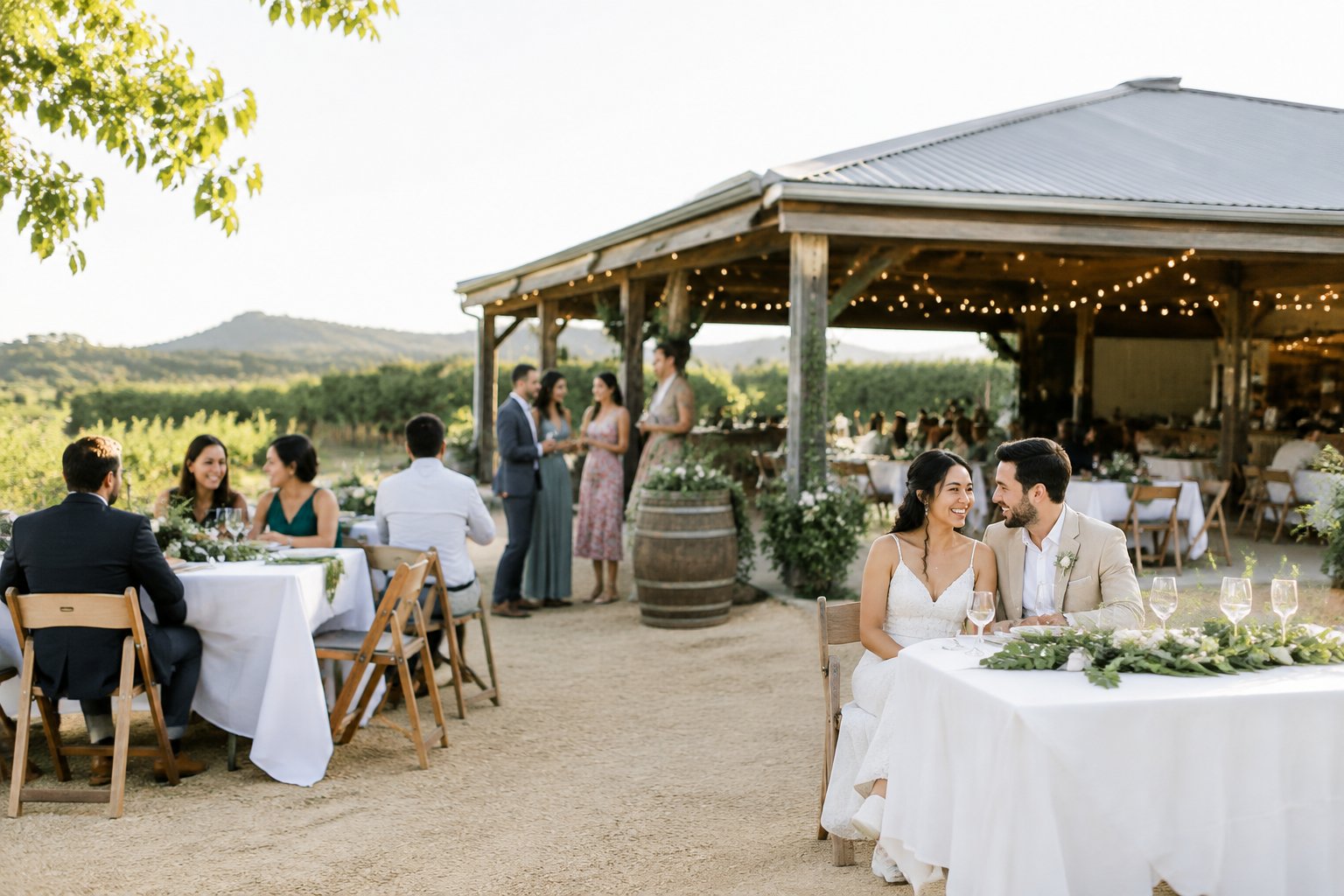 A couple and guests celebrating at an elegant outdoor wedding venue.