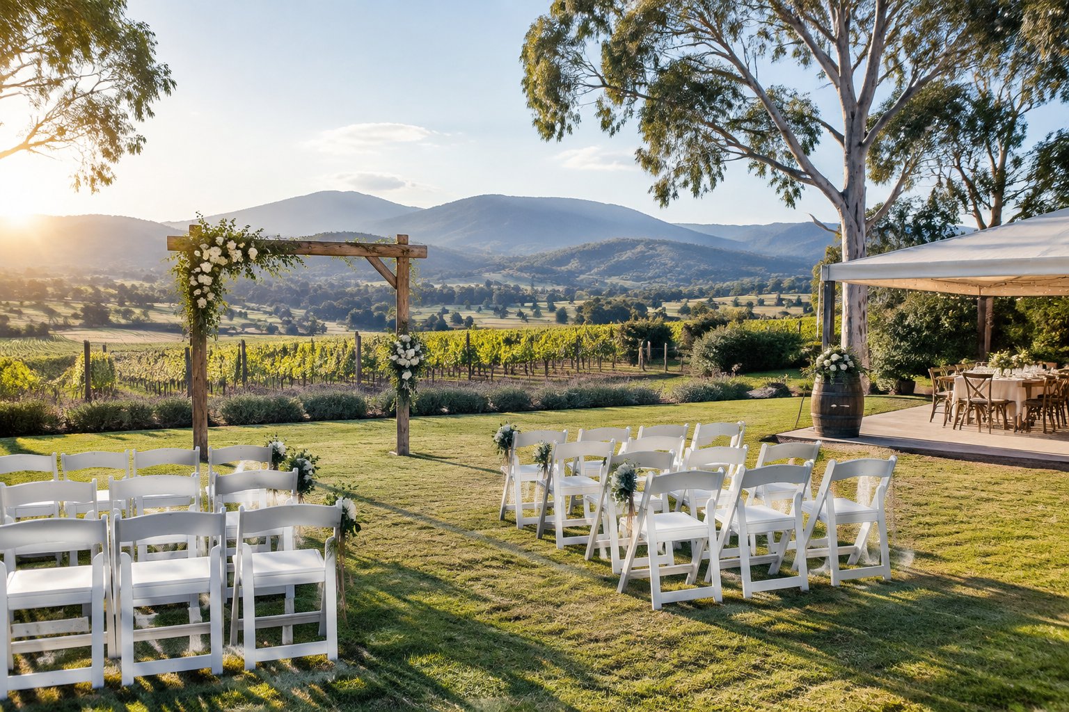 A simple outdoor wedding setup at a rustic Yarra Valley venue with vineyard hills in the background.