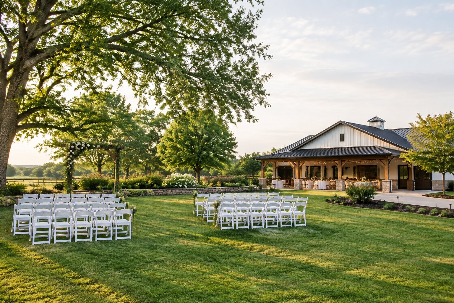 A modest wedding venue with white chairs arranged on a landscaped lawn beside a simple reception building.