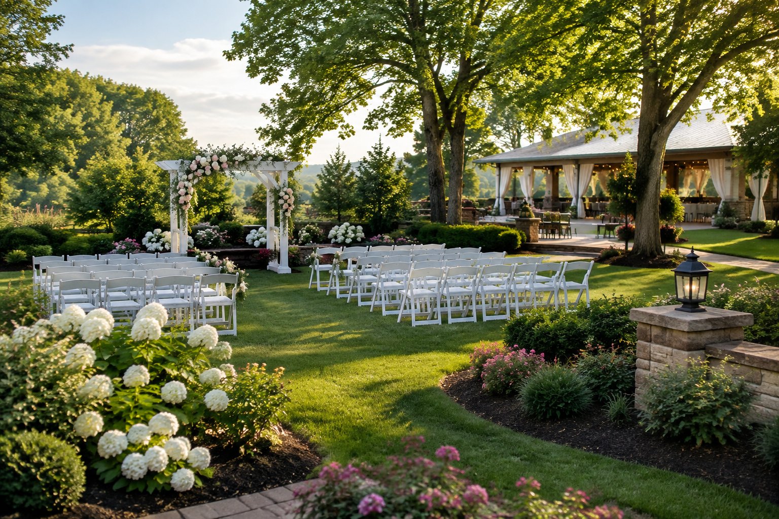 A garden wedding ceremony area with a white floral arch, arranged chairs, flower beds, lawns, and mature trees.