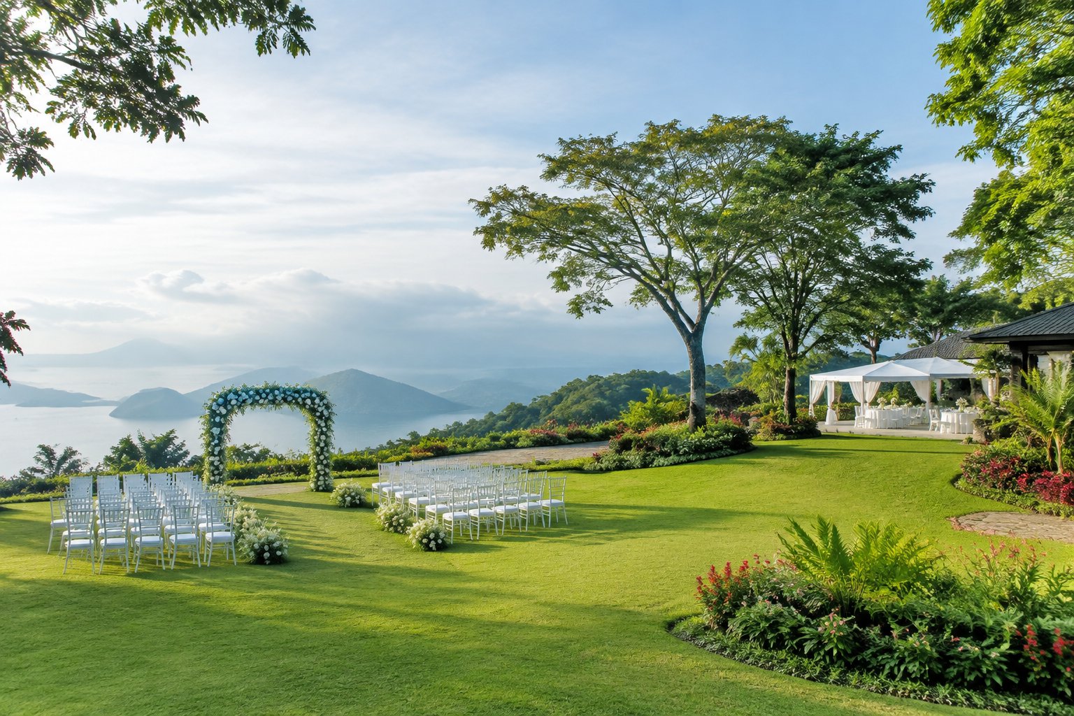 A lush garden wedding venue in Tagaytay with white chairs, a floral arch, and scenic mountain views.