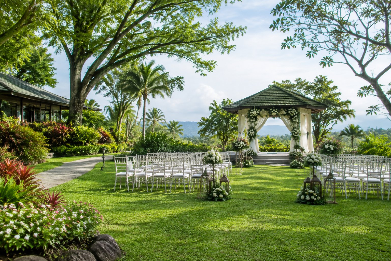 A landscaped tropical garden with a decorated wedding arch and neatly arranged ceremony chairs.