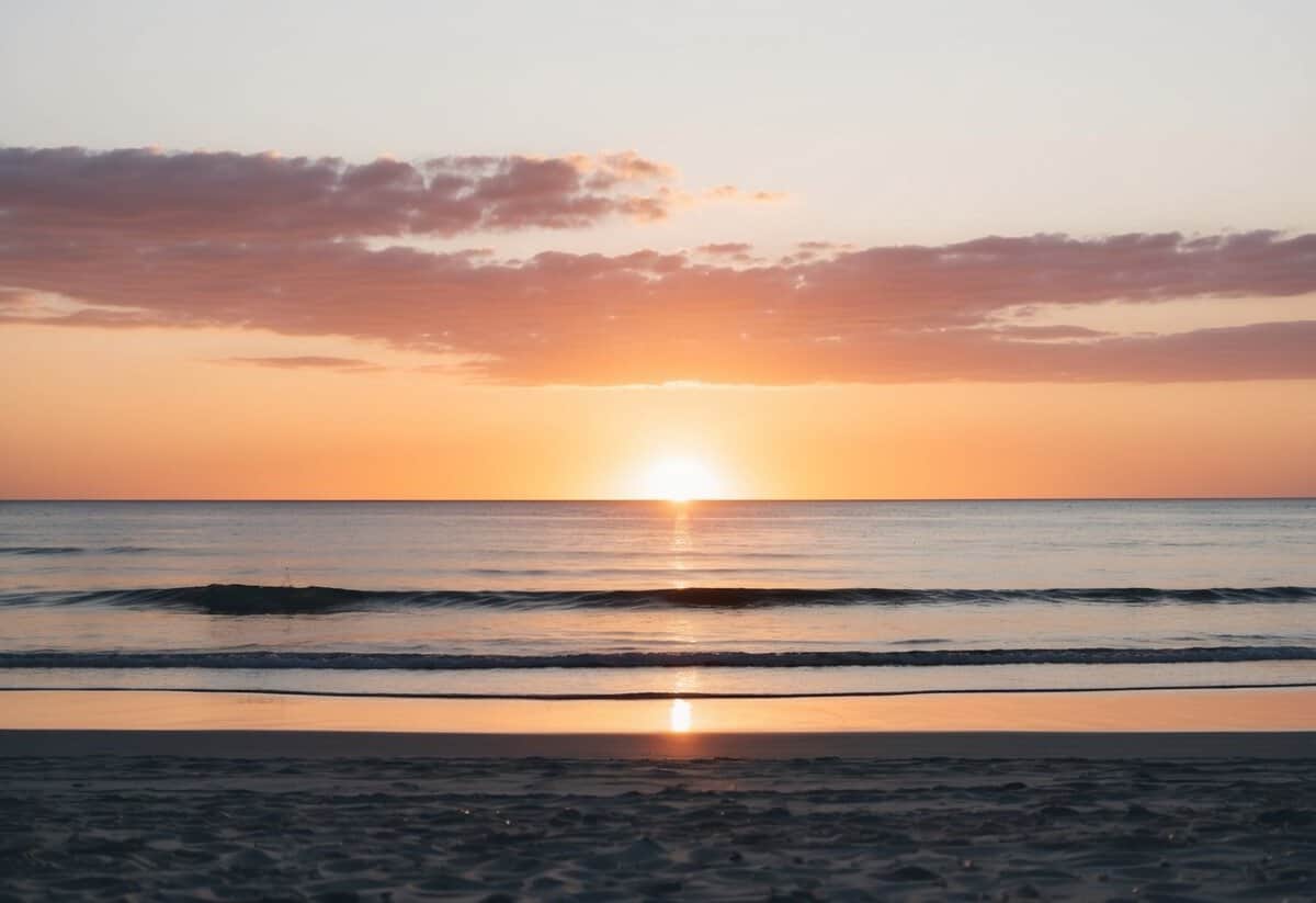 A serene sunset over a tranquil beach, with soft golden light casting a warm glow on the sand and gentle waves