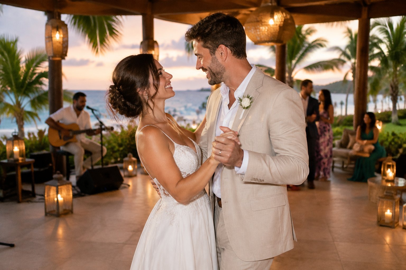 A newlywed couple dances at a beachfront resort while a musician performs nearby.