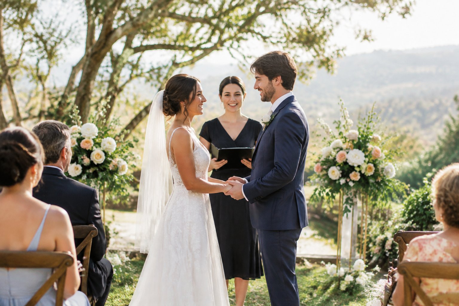 A couple exchanging vows at an outdoor garden wedding as guests watch.