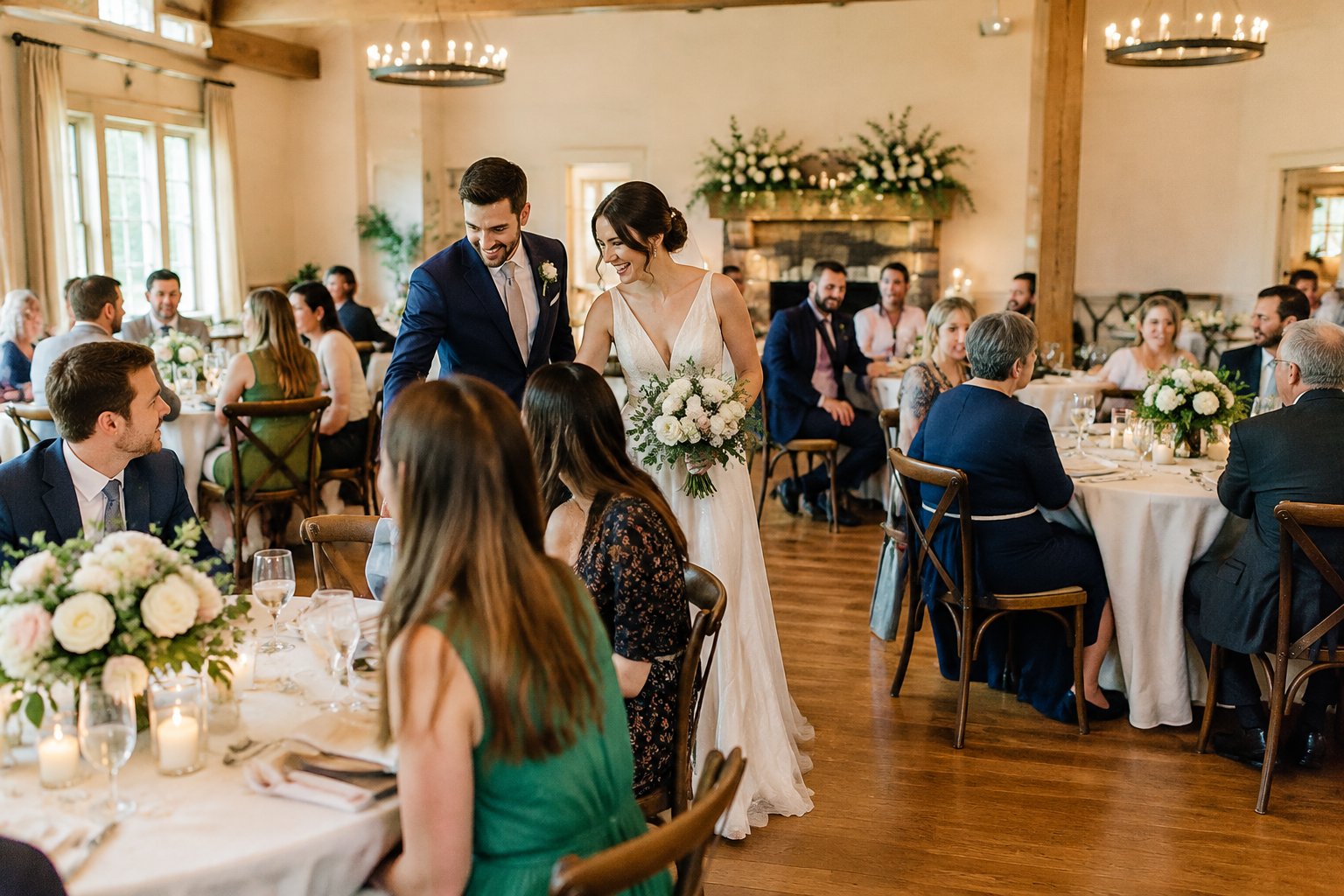 A newlywed couple celebrates with guests at a wedding reception.