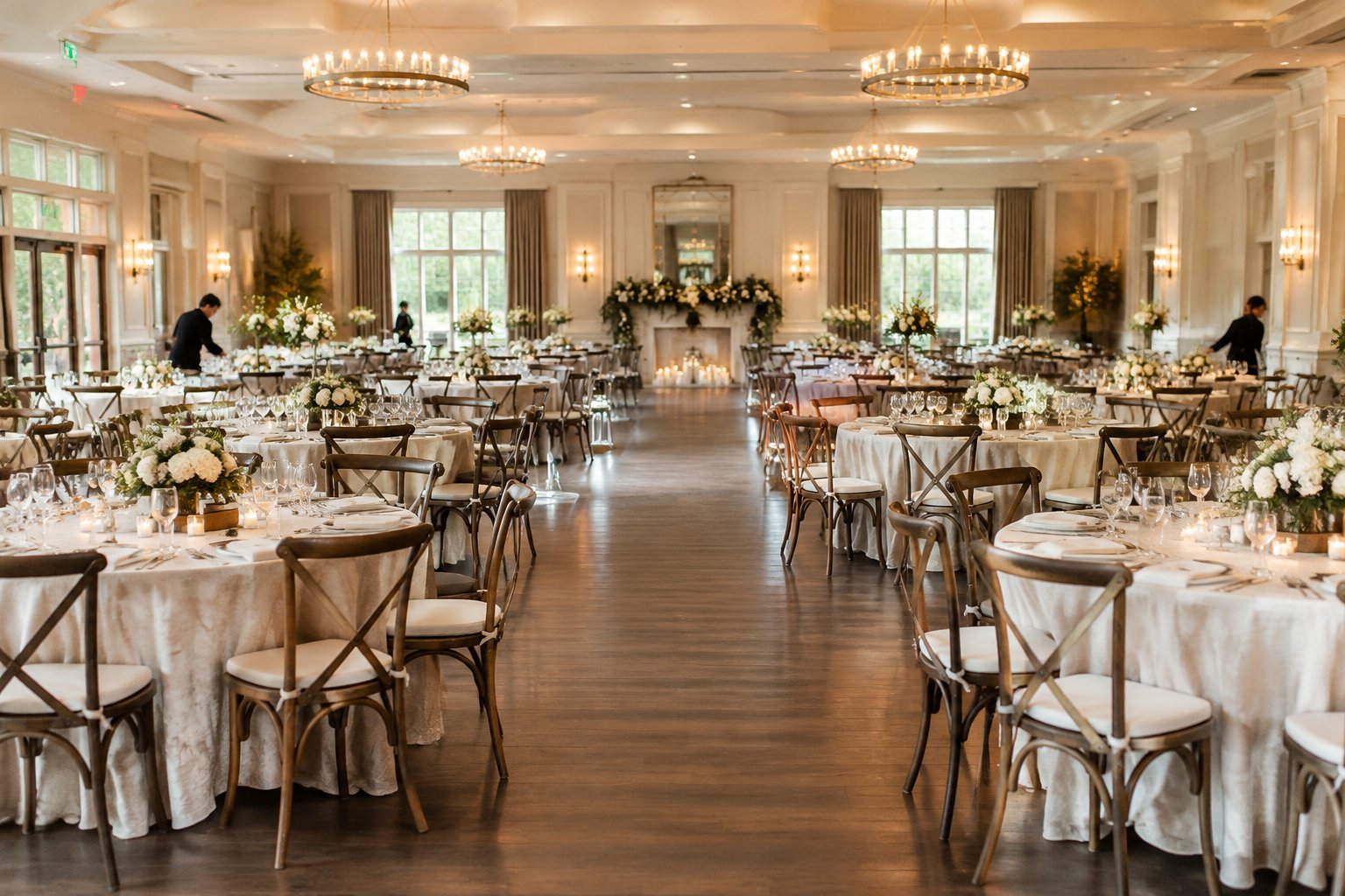 A spacious wedding reception venue with tables and chairs arranged for a large group.
