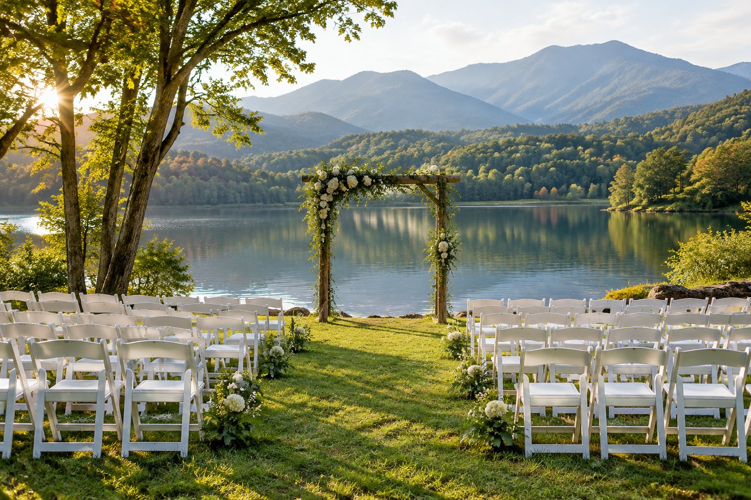 A wedding ceremony setup beside a lake with the Smoky Mountains in the background.